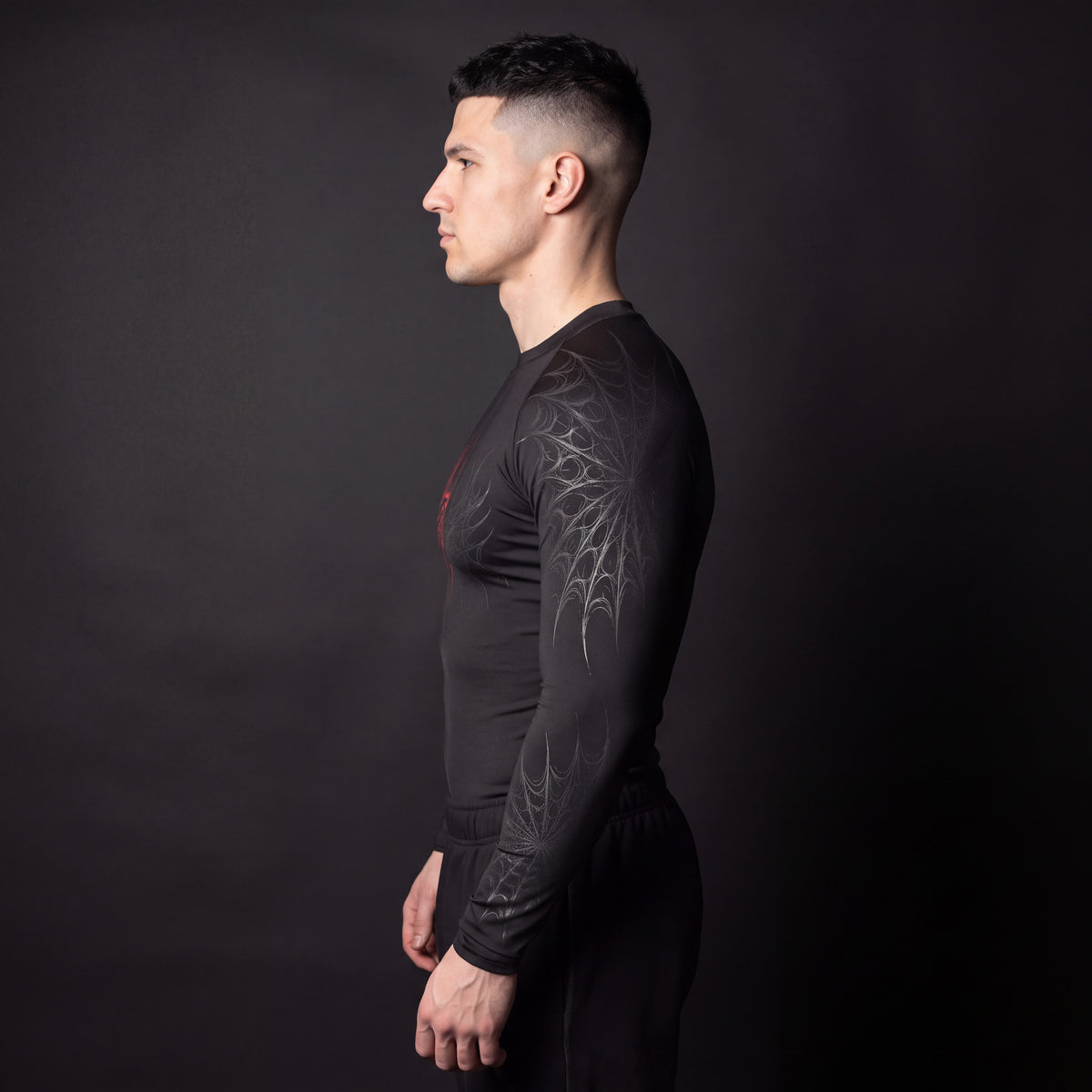 Symbiote Compression Shirt side profile showing gothic spiderweb sleeve print and compression fit