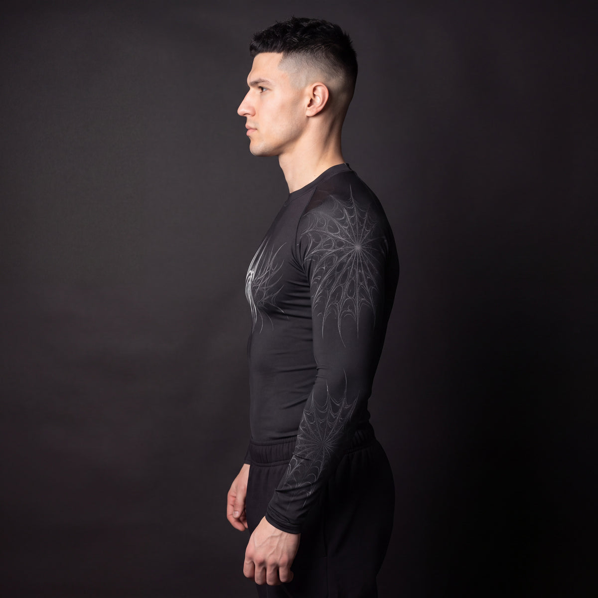 Symbiote Compression Shirt in Black & White, side profile showing gothic spiderweb sleeve print and compression fit